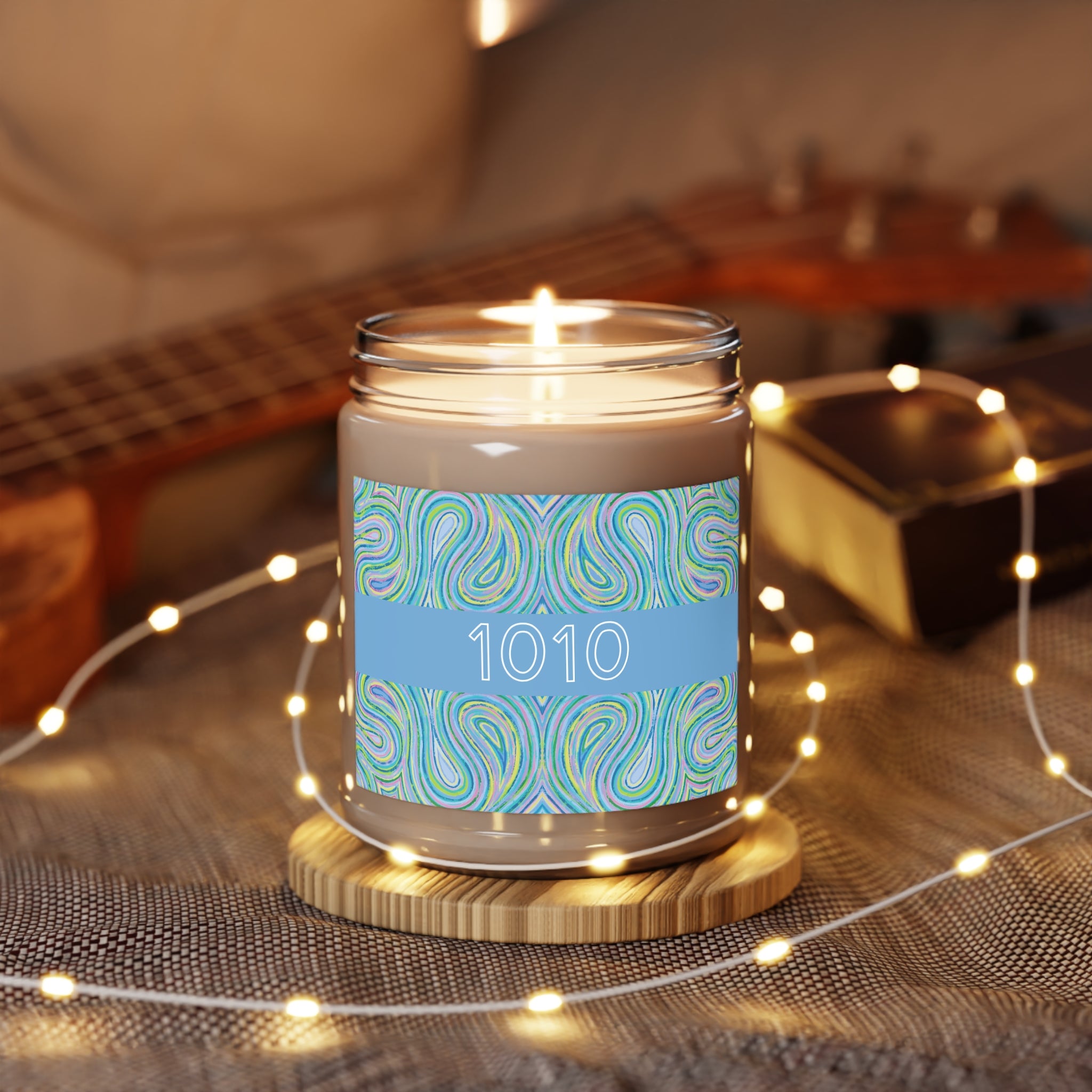  1010 angel number candle surrounded by twinkle string lights