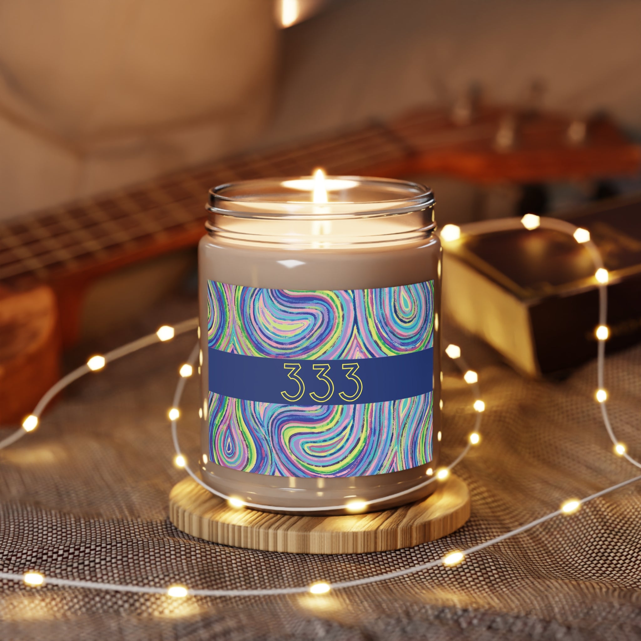  333 angel number candle surrounded by twinkle string lights