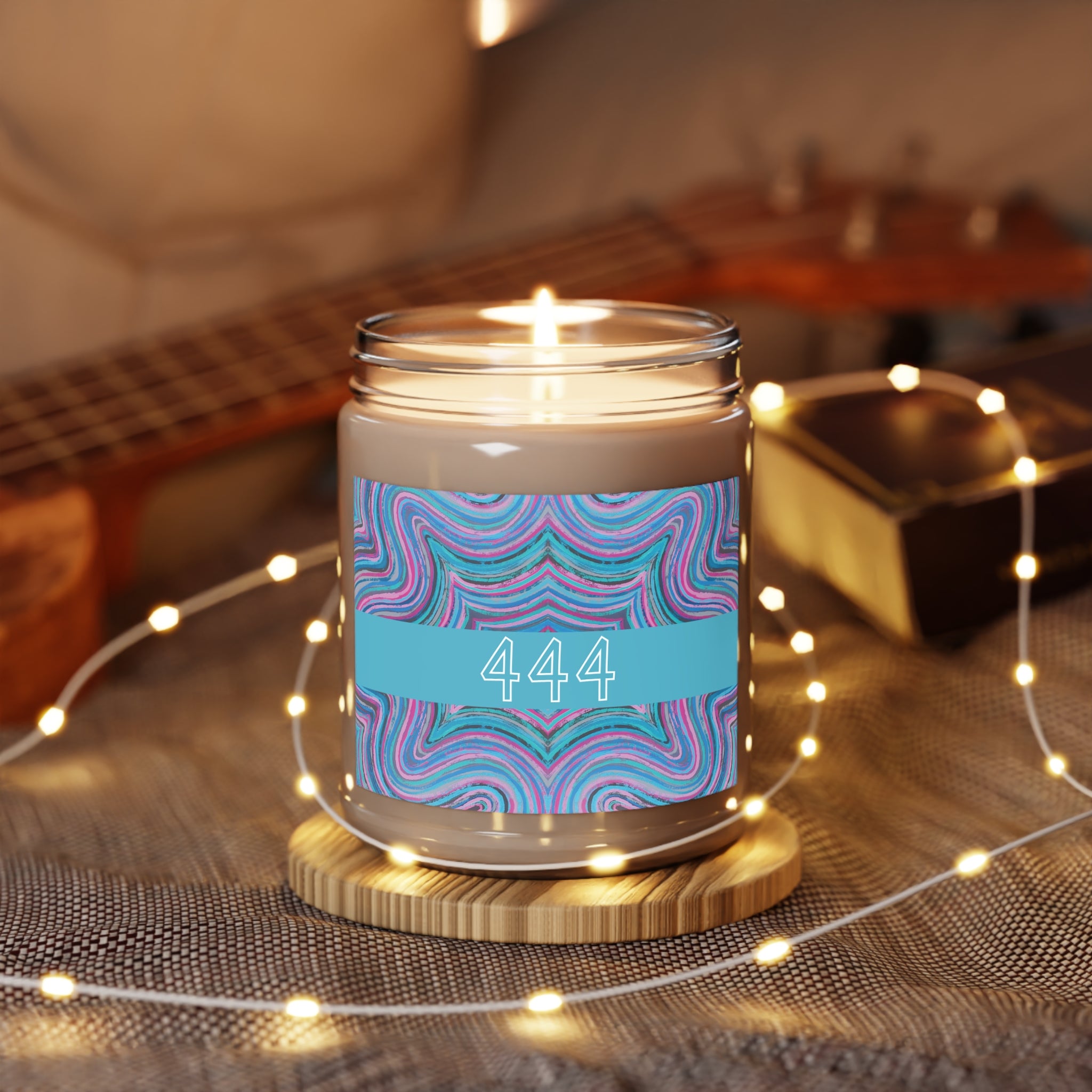  444 angel number candle surrounded by twinkle string lights